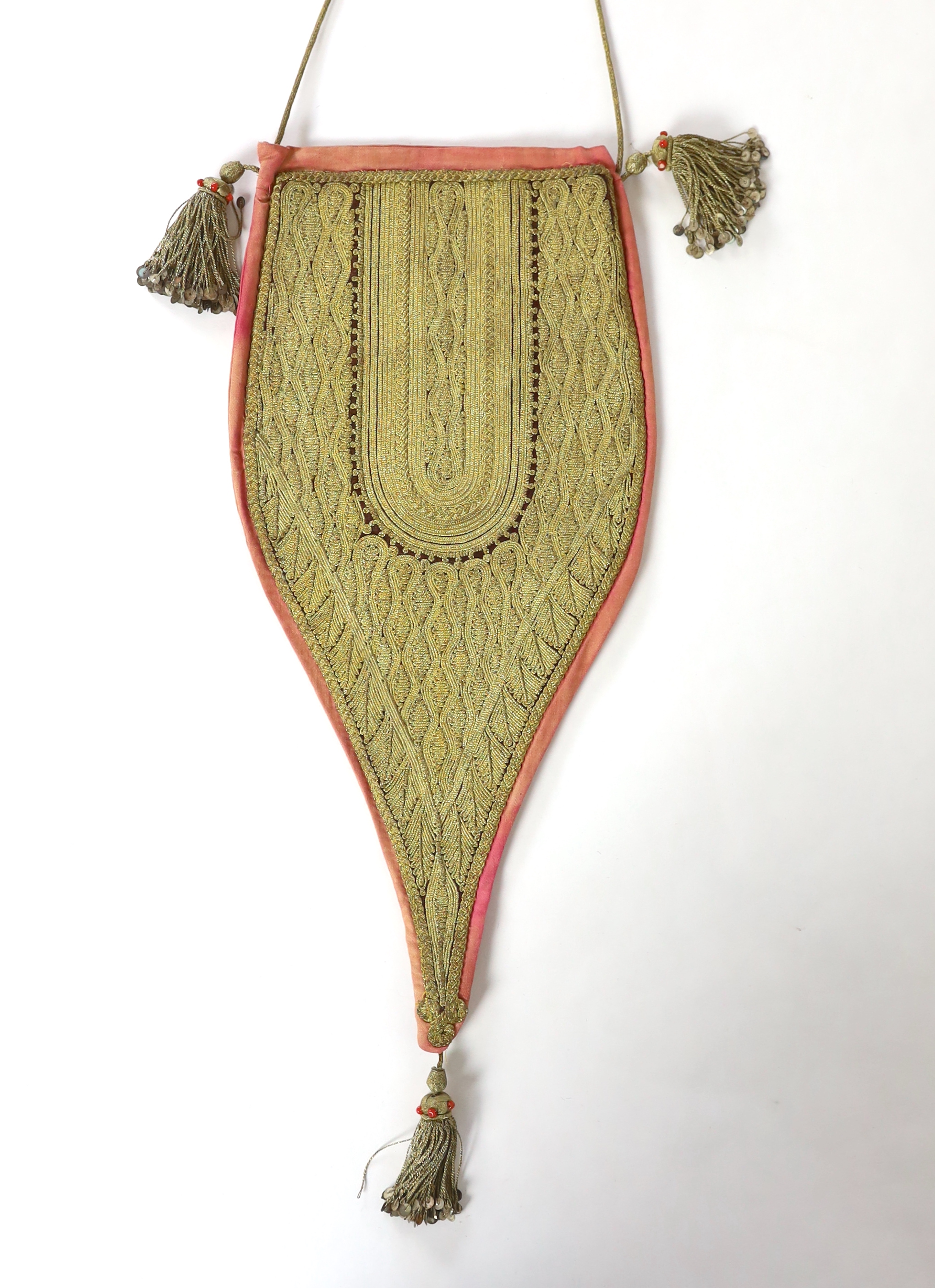 A heavily worked gold thread bag, probably Ottoman, 19th/20th century, with tassels and sequin and coral bead ornamentation, 38cm to end of tassel at base, 60cm strap / cord to end of tassel